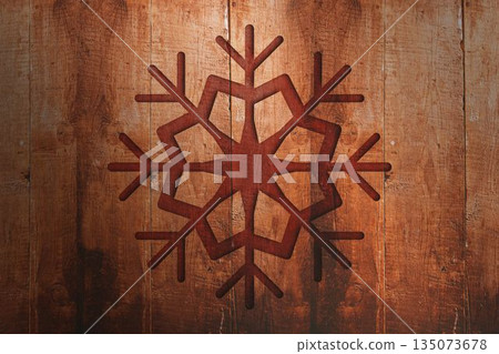 Displaying stylized six-armed snowflake flat design on vertical wooden planks, highlighting texture 135073678