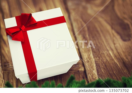Flat design white gift box is sitting on wooden tabletop, with red ribbon bow, pine branches 135073702