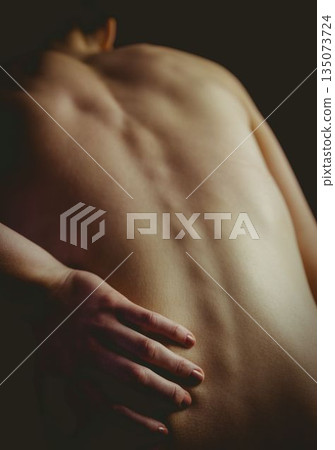 Woman's bare back and spine is being accentuated in 3D render by soft highlights and shadows Woman's bare back and spine is being accentuated in 3D render by soft highlights and shadows 135073724