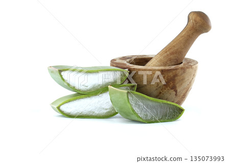 Fresh aloe vera slices and wooden mortar with pestle for natural remedies and skincare Fresh aloe vera slices and wooden mortar with pestle for natural remedies and skincare 135073993