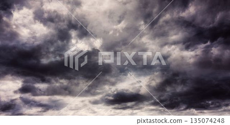 Dense dark grey clouds are being shown in open sky flat design, featuring layered storm patterns Dense dark grey clouds are being shown in open sky flat design, featuring layered storm patterns 135074248