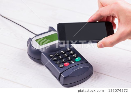 Man using smartphone to express pay Man using smartphone to express pay 135074372