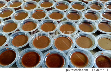 Rows Of Indonesian Chocolate Pudding Agar Agar Cups Ready For Packaging And Sale 135074501