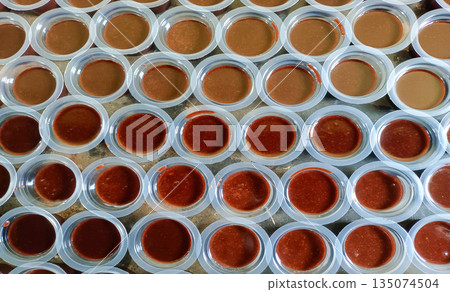 Overhead View Of Traditional Indonesian Chocolate Jelly Agar Agar In Small Plastic Cups 135074504