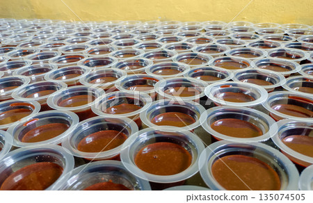 Batch Of Traditional Chocolate Agar Agar Pudding Cups Arranged On Table Background 135074505