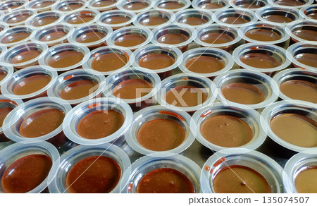 Array Of Traditional Indonesian Chocolate Agar Agar Cups In Natural Lighting Array Of Traditional Indonesian Chocolate Agar Agar Cups In Natural Lighting 135074507