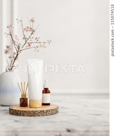 Skincare dropper amber glass bottle and lotion tube aside diffuser on wooden tray at marble table. 135074518