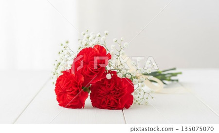 Mother's Day image of red carnations and ribbons on a pink background 135075070