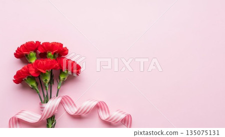 Mother's Day image of red carnations and ribbons on a pink background 135075131