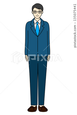 A young man wearing a suit and glasses standing A young man wearing a suit and glasses standing 135075441