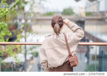 woman traveler travel in Chengdu city. Happy Tourist sightseeing in Taikoo Li Chengdu, located in the Jinjiang District, near the Chunxi Road. Famous landmark for tourism attraction in Sichuan, China 135075830