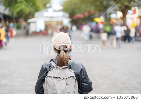 Happy woman traveler travel in Dujiangyan city. Tourist sightseeing Guanxian Ancient City near Chengdu. Landmark and popular for tourism attraction in Sichuan, China 135075860