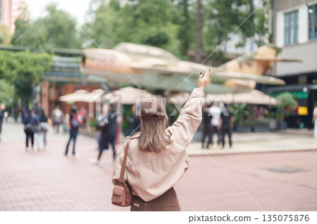Happy woman traveler travel in Chengdu city. Tourist sightseeing and shopping in Eastern Suburb Memory or Dongjiao Ji Yi. Famous Landmark for tourism attraction in Sichuan, China Happy woman traveler travel in Chengdu city. Tourist sightseeing and shopping in Eastern Suburb Memory or Dongjiao Ji Yi. Famous Landmark for tourism attraction in Sichuan, China 135075876