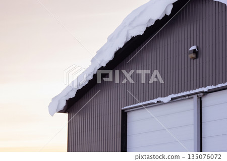 Warehouse in snow, industrial building in sunset light in winter. 135076072