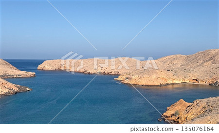 Serene Coastal Vista, Tranquil Bay With Rocky Islands, Peaceful Shoreline Featuring Clear Blue Skies And Limestone Cliffs, Calm Waters Surrounded By Rocky Isles Under Bright Sunlight And Open Horizon Serene Coastal Vista, Tranquil Bay With Rocky Islands, Peaceful Shoreline Featuring Clear Blue Skies And Limestone Cliffs, Calm Waters Surrounded By Rocky Isles Under Bright Sunlight And Open Horizon 135076164