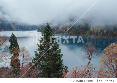 Scenery Jiuzhaigou national park in Sichuan, China. Beautiful Long lake and snow mountain in Autumn season. Famous Landmark and Vacation near Chengdu, China. Asia travel concept Scenery Jiuzhaigou national park in Sichuan, China. Beautiful Long lake and snow mountain in Autumn season. Famous Landmark and Vacation near Chengdu, China. Asia travel concept 135076265