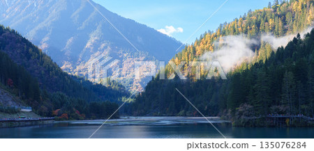 Scenery Jiuzhaigou national park in Sichuan, China. Beautiful of Arrow Bamboo Lake and snow mountain in Autumn season. Famous Landmark and Vacation near Chengdu, China. Asia travel concept Scenery Jiuzhaigou national park in Sichuan, China. Beautiful of Arrow Bamboo Lake and snow mountain in Autumn season. Famous Landmark and Vacation near Chengdu, China. Asia travel concept 135076284