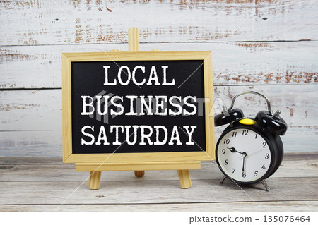 Local Business Saturday text written on blackboard with alarm clock on wooden background 135076464