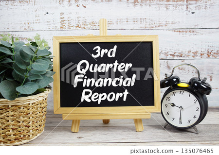 3rd Quarter Financial Report text written on blackboard with alarm clock on wooden background 135076465