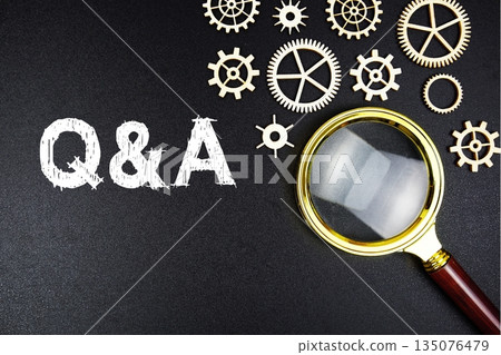 Questions and Answers text message with magnifying glass on black background Questions and Answers text message with magnifying glass on black background 135076479