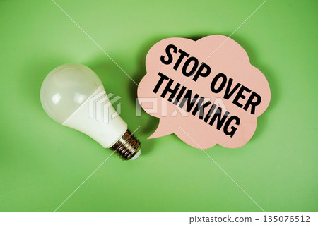 Stop Over Thinking text with light bulb on green background 135076512
