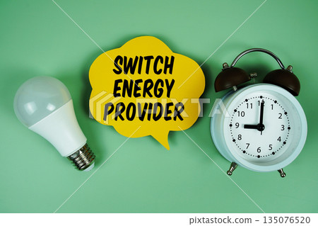 Switch Energy Provider with light bulb and alarm clock on green background 135076520