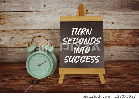 Turn Seconds Into Success text on easel blackboard with alarm clock on wooden background Turn Seconds Into Success text on easel blackboard with alarm clock on wooden background 135076688