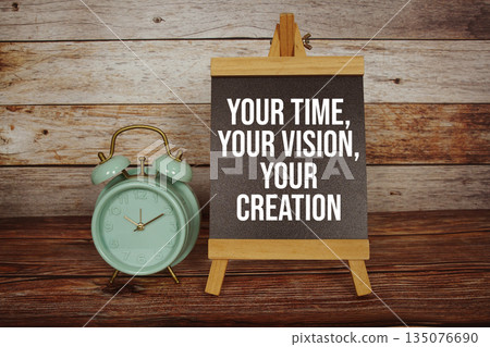 Your Time, Your Vision, Your Creation text on easel blackboard with alarm clock on wooden background 135076690