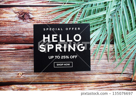 Hello Spring Sale 25% off with green leaf on wooden background Promotion Offer Discount Retail Shopping Concept 135076697