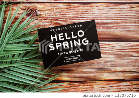 Hello Spring Sale 85% off with green leaf on wooden background Promotion Offer Discount Retail Shopping Concept 135076710
