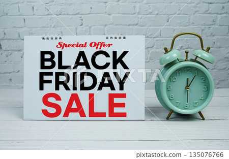 Black Friday Sale text Promotion and Marketing with alarm clock on wooden background Black Friday Sale text Promotion and Marketing with alarm clock on wooden background 135076766