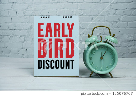 Early Bird Discount text Promotion and Marketing with alarm clock on wooden background Early Bird Discount text Promotion and Marketing with alarm clock on wooden background 135076767