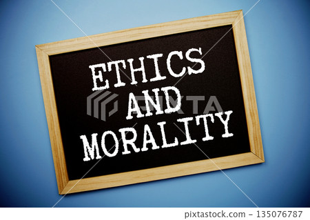 Ethics And Morality text written on chalkboard flat lay on blue background Ethics And Morality text written on chalkboard flat lay on blue background 135076787