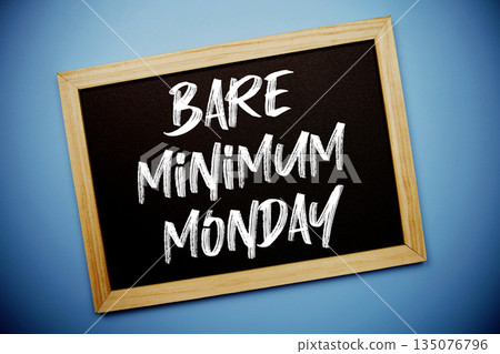 Bare Minimum Monday text written on chalkboard flat lay on blue background 135076796