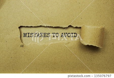 Mistakes To Avoid message written on craft paper with torn paper background 135076797