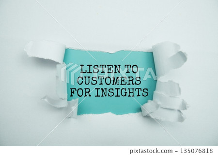 Listen to customers for insights message written on blue paper with torn paper background 135076818