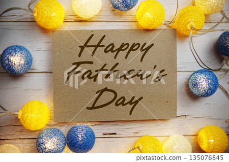 Happy Father's Day text with LED cotton balls decorate on wooden background 135076845