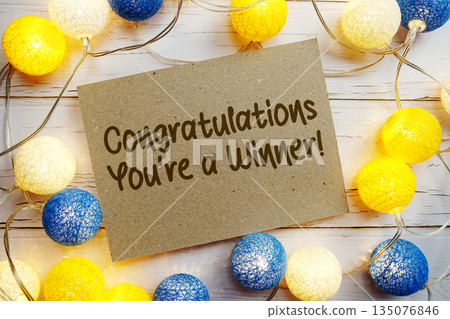 Congratulations You're a Winner! text with LED cotton balls decorate on wooden background 135076846