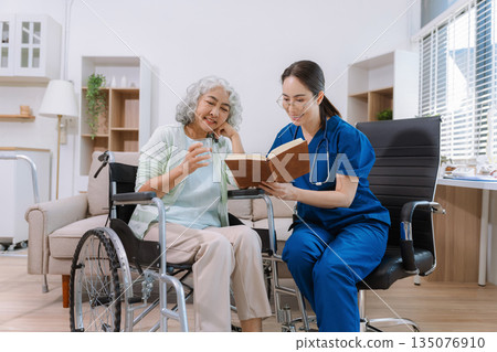 Helpful volunteers caring for elderly woman at home health care. Helpful volunteers caring for elderly woman at home health care. 135076910