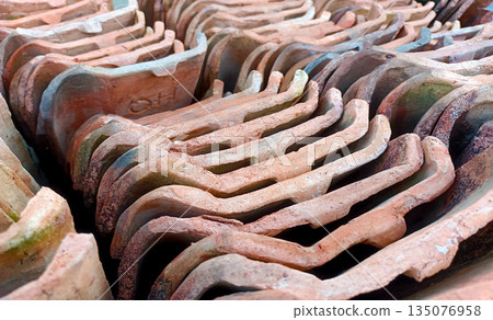 Perspective View of Stacked Clay Roof Tiles, Traditional Terracotta Tiles with Maker Mark Perspective View of Stacked Clay Roof Tiles, Traditional Terracotta Tiles with Maker Mark 135076958