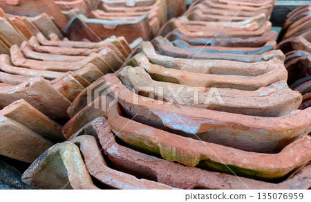 Angled View of Stacked Traditional Clay Roof Tiles, Terracotta Material Texture Angled View of Stacked Traditional Clay Roof Tiles, Terracotta Material Texture 135076959