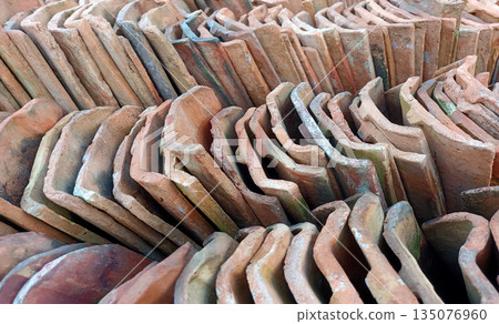 Repeating Pattern of Stacked Clay Roof Tiles, Red Terracotta Construction Materials Repeating Pattern of Stacked Clay Roof Tiles, Red Terracotta Construction Materials 135076960