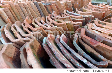 Close Up View of Stacked Red Clay Roof Tiles, Traditional Building Material for House Close Up View of Stacked Red Clay Roof Tiles, Traditional Building Material for House 135076961