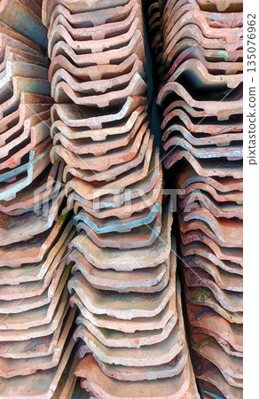 High Angle Vertical Stack of Traditional Red Clay Roof Tiles, Terracotta Construction Material Texture High Angle Vertical Stack of Traditional Red Clay Roof Tiles, Terracotta Construction Material Texture 135076962