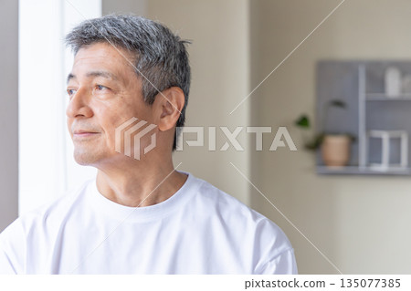 Senior men standing at the windowside Senior men standing at the windowside 135077385