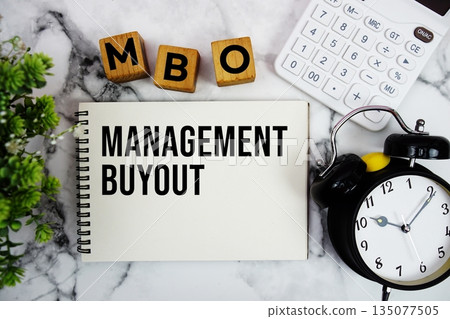 MBO Management Buyout text with calculator and alarm clock on marble background MBO Management Buyout text with calculator and alarm clock on marble background 135077505