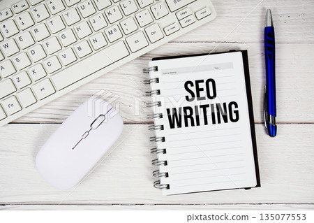 SEO Writing text with keyboard and wireless mouse on wooden background 135077553