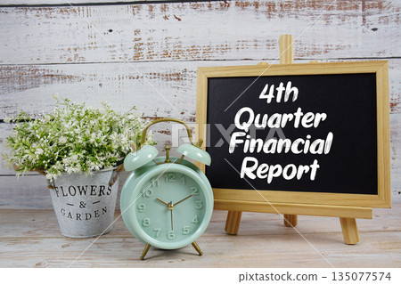 4th Quarter Financial Report text written on blackboard with alarm clock on wooden background 4th Quarter Financial Report text written on blackboard with alarm clock on wooden background 135077574