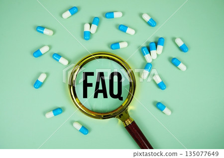 FAQ with medicine capsule and magnifying glass on green background FAQ with medicine capsule and magnifying glass on green background 135077649