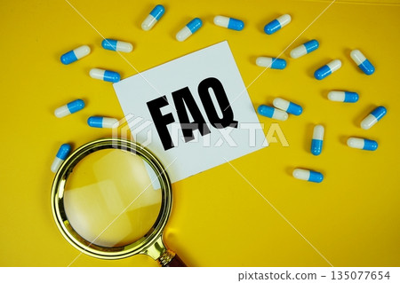 FAQ with medicine capsule and magnifying glass on yellow background FAQ with medicine capsule and magnifying glass on yellow background 135077654